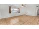 Bright living room featuring tile floors and a ceiling fan at 5321 W Country Gables Dr, Glendale, AZ 85306