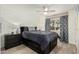 Bright bedroom with a queen-size bed, dresser, and ceiling fan at 5518 E Lindstrom Ln # A12, Mesa, AZ 85215