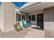 Private patio with brick flooring and teal chairs, perfect for relaxing outdoors at 5518 E Lindstrom Ln # A12, Mesa, AZ 85215