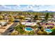 Aerial view showcasing a house with a pool and a neighborhood backdrop at 6030 E Crocus Dr, Scottsdale, AZ 85254