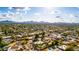 Wide aerial view of a residential neighborhood, featuring numerous houses and pools at 6030 E Crocus Dr, Scottsdale, AZ 85254