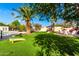 Landscaped backyard with artificial turf, pool, and games at 6030 E Crocus Dr, Scottsdale, AZ 85254