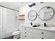 Modern bathroom with double vanity, large mirrors, and a shower/tub combo at 6030 E Crocus Dr, Scottsdale, AZ 85254