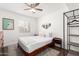 Bedroom with wooden bed frame, ceiling fan, and plenty of natural light at 6030 E Crocus Dr, Scottsdale, AZ 85254