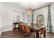 Dining room with a dark wood table, six chairs, and a large window at 6030 E Crocus Dr, Scottsdale, AZ 85254