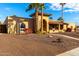 Tan house with a large front yard, palm trees, and a walkway to the entrance at 6030 E Crocus Dr, Scottsdale, AZ 85254