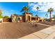 Tan house with a large front yard, palm trees, and a walkway to the entrance at 6030 E Crocus Dr, Scottsdale, AZ 85254