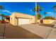 Tan stucco house with white garage door and desert landscaping at 6030 E Crocus Dr, Scottsdale, AZ 85254