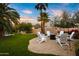 Relaxing fire pit area in the backyard with white chairs at 6030 E Crocus Dr, Scottsdale, AZ 85254