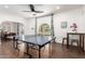 Game room with ping pong table, decorative wall art, and wood-look tile floor at 6030 E Crocus Dr, Scottsdale, AZ 85254