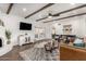 Living room with brown leather couch, wood-beam ceiling, and a white fireplace at 6030 E Crocus Dr, Scottsdale, AZ 85254