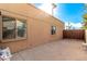 Large patio area adjacent to the house with wooden gate at 6030 E Crocus Dr, Scottsdale, AZ 85254