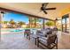 Covered patio with seating area overlooking the pool and backyard at 6030 E Crocus Dr, Scottsdale, AZ 85254