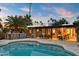 Stunning pool and outdoor kitchen area at sunset at 6030 E Crocus Dr, Scottsdale, AZ 85254