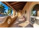 Covered porch with arched entryways, and comfortable seating at 6030 E Crocus Dr, Scottsdale, AZ 85254