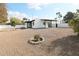 Large backyard with gravel and a small tree at 634 E Calavar Rd, Phoenix, AZ 85022