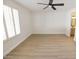 Bright bedroom with ceiling fan and hardwood floors at 634 E Calavar Rd, Phoenix, AZ 85022