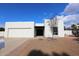 Single-story home with white exterior, two-car garage, and landscaping at 634 E Calavar Rd, Phoenix, AZ 85022