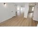 Bright hallway with light wood flooring, leading to other rooms at 634 E Calavar Rd, Phoenix, AZ 85022