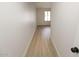 Long hallway with light walls and hardwood flooring at 634 E Calavar Rd, Phoenix, AZ 85022