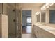 Modern bathroom with double vanity, a glass shower, and white cabinets at 7137 E Rancho Vista Dr # 6010, Scottsdale, AZ 85251