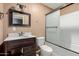 Bathroom with tub, shower, and dark wood vanity at 7501 E Pierce St, Scottsdale, AZ 85257