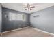 Bedroom with gray walls and ceiling fan at 7501 E Pierce St, Scottsdale, AZ 85257