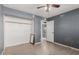 Simple bedroom with wood-look floors and a mirrored closet at 7501 E Pierce St, Scottsdale, AZ 85257