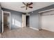 Bedroom with gray walls, ceiling fan, and access to bathroom at 7501 E Pierce St, Scottsdale, AZ 85257