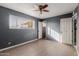 Bedroom with gray walls, ceiling fan, and laminate floors at 7501 E Pierce St, Scottsdale, AZ 85257