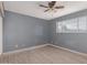 Bedroom with gray walls, ceiling fan, and laminate floors at 7501 E Pierce St, Scottsdale, AZ 85257