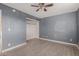 Bedroom with gray walls, ceiling fan, and a closet at 7501 E Pierce St, Scottsdale, AZ 85257