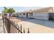 Front view of a single-story home with a rock garden and a metal fence at 7501 E Pierce St, Scottsdale, AZ 85257