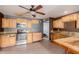 Kitchen with wood cabinets, granite counters, and stainless steel appliances at 7501 E Pierce St, Scottsdale, AZ 85257