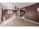 Bright living room with ceiling fan and laminate floors at 7501 E Pierce St, Scottsdale, AZ 85257