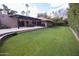 Spacious backyard with grassy lawn, patio, and pergola at 7701 S Butte Ave, Tempe, AZ 85284