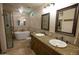 Elegant bathroom with double sinks, a soaking tub, and a walk-in shower at 7701 S Butte Ave, Tempe, AZ 85284