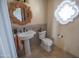 Powder room with pedestal sink and decorative mirror at 7701 S Butte Ave, Tempe, AZ 85284