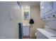 Bathroom with toilet, sink, and stackable washer/dryer at 7750 E Broadway Rd # 83, Mesa, AZ 85208