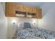 Small bedroom with wood cabinets and a comfortable bed at 7750 E Broadway Rd # 83, Mesa, AZ 85208