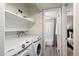 Convenient laundry room with washer, dryer, and shelving at 8578 E Indian School Rd # I, Scottsdale, AZ 85251