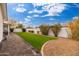 Landscaped backyard with artificial turf and paver walkway at 8602 E Plaza Ave, Scottsdale, AZ 85250