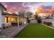 Sunset view of backyard, patio, and home exterior at 8602 E Plaza Ave, Scottsdale, AZ 85250