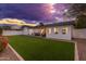 Backyard view of home at sunset with artificial turf at 8602 E Plaza Ave, Scottsdale, AZ 85250