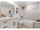 Modern bathroom with a soaking tub and white vanity at 8602 E Plaza Ave, Scottsdale, AZ 85250