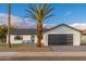 Modern single story home with a two car garage and landscaped front yard at 8602 E Plaza Ave, Scottsdale, AZ 85250