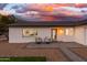 Front view of the home with seating area on patio at 8602 E Plaza Ave, Scottsdale, AZ 85250