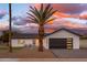 Modern home exterior with a palm tree and driveway at 8602 E Plaza Ave, Scottsdale, AZ 85250