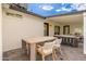 Outdoor patio with seating area, dining table, and view of the house at 8602 E Plaza Ave, Scottsdale, AZ 85250