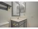 Clean bathroom featuring a vanity with a gray cabinet and a mirrored medicine cabinet at 8728 W Vale Dr, Phoenix, AZ 85037